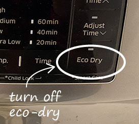 close up of the "eco-dry" button of the dryer