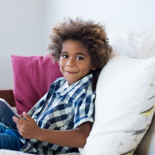 little boy on couch with tablet