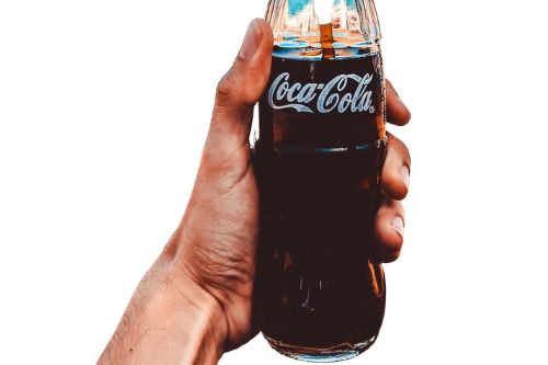 A person holding a jar of coca cola presumably to be used for a lice treatment