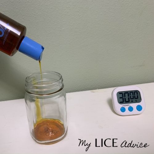 T-gel shampoo being poured into a clear jar full of head lice