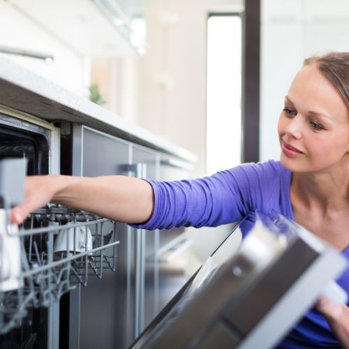 woman putting lice infested brushes in the dishwasher