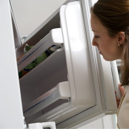 woman putting lice infested brushes in the freezer