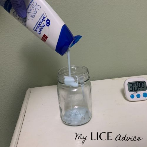 head and shoulders shampoo being poured into a clear jar full of head lice