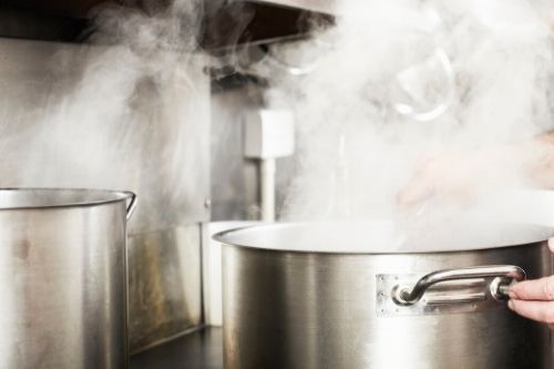 pot of boiling water for soaking lice infested brushes