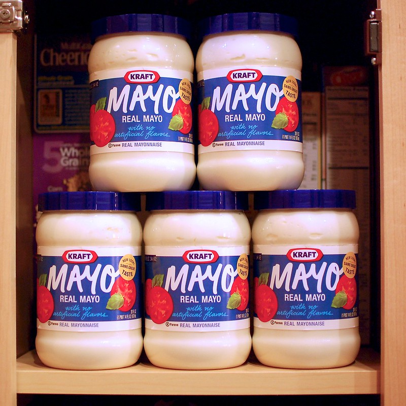 5 jars of mayonnaise in the cupboard, stacked, presumably to be used for head lice