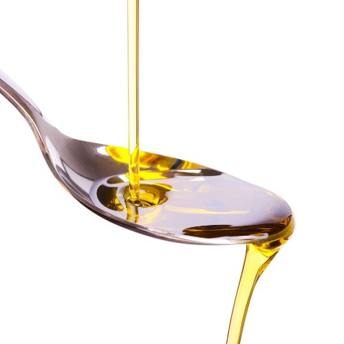 olive oil dripping on a spoon