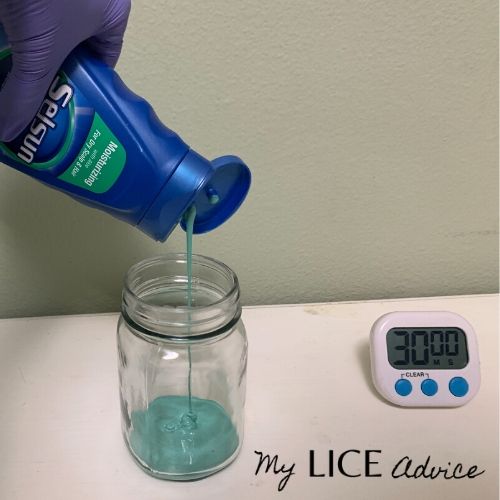 Selsun blue being poured into a jar full of lice