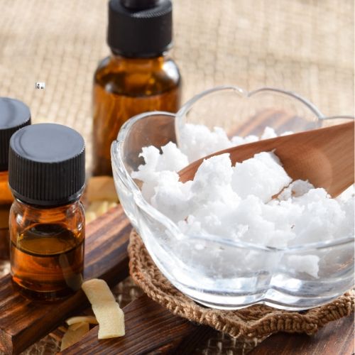 bottle of tea tree oil and coconut oil, presumably to be used as a lice treatment