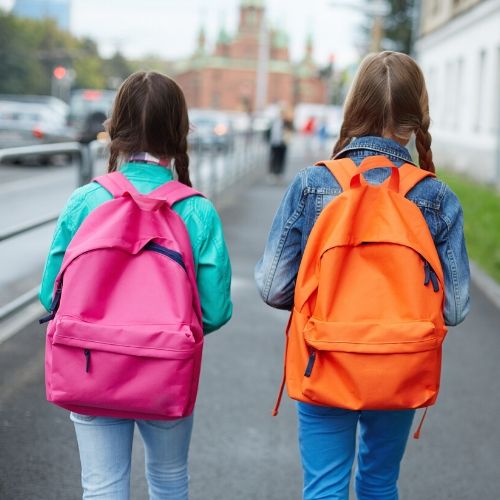 two girls walking with backpacks