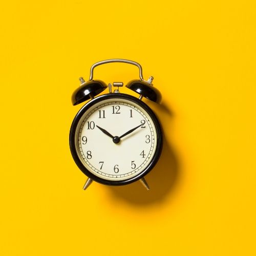 clock against a yellow background