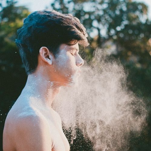 man with powdered substance like baking soda in his face