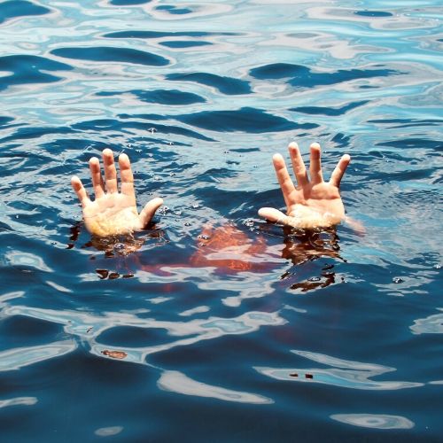 person with hair in water, presumably to kill lice in the pool