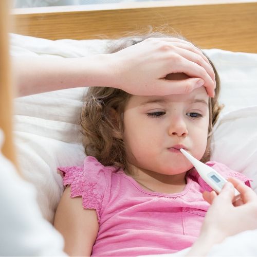 A mother is checking her daughter's temperature