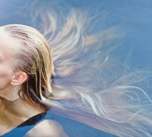 woman presumably with lice has long hair in the chlorinated water