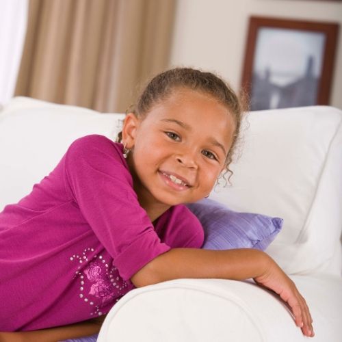 A girl sitting on a couch.