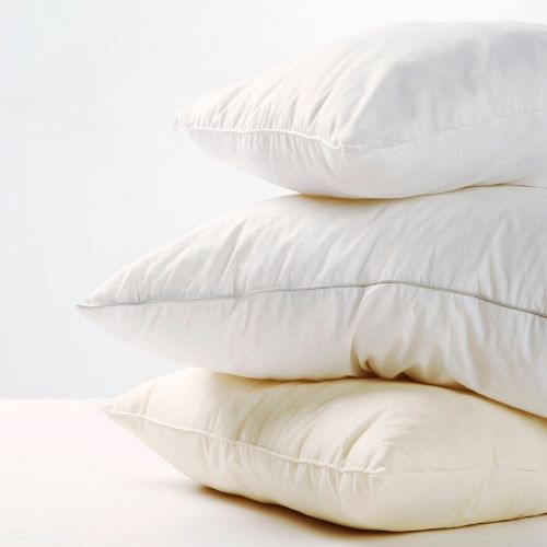 3 white pillows stacked on each other.