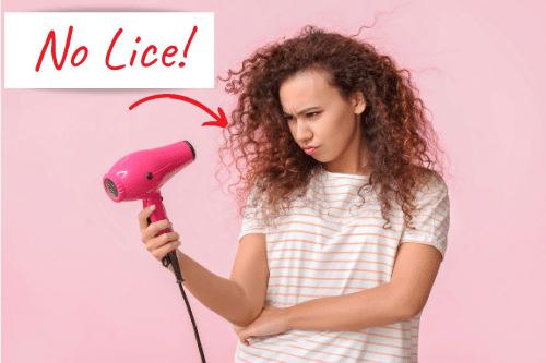 woman blow-drying her hair, which can prevent head lice