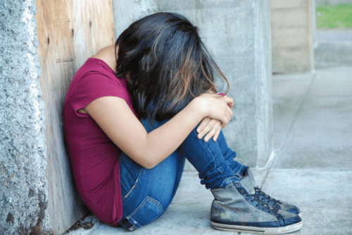 girl looking sad with lice