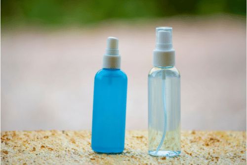 two spray bottles with lice repelling essential oil blends in them