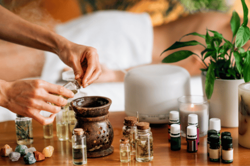 woman blending multiple essential oils together
