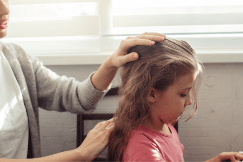 woman checking her child for lice