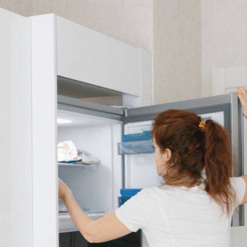 woman putting hair brush with lice in the freezer