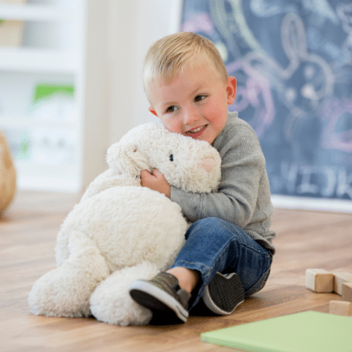 child snuggling a stuffed animal tightly, presumably with lice