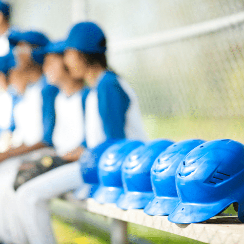 baseball helmets lined in a row. Baseball helmets presumably infested with lice