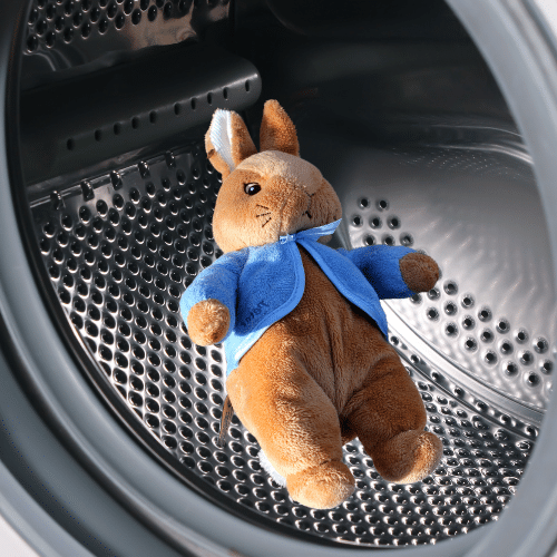 stuffed animal rabbit in the dryer, being cleaned for lice
