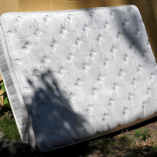 a mattress presumably with lice is placed outside to clean or spray for lice